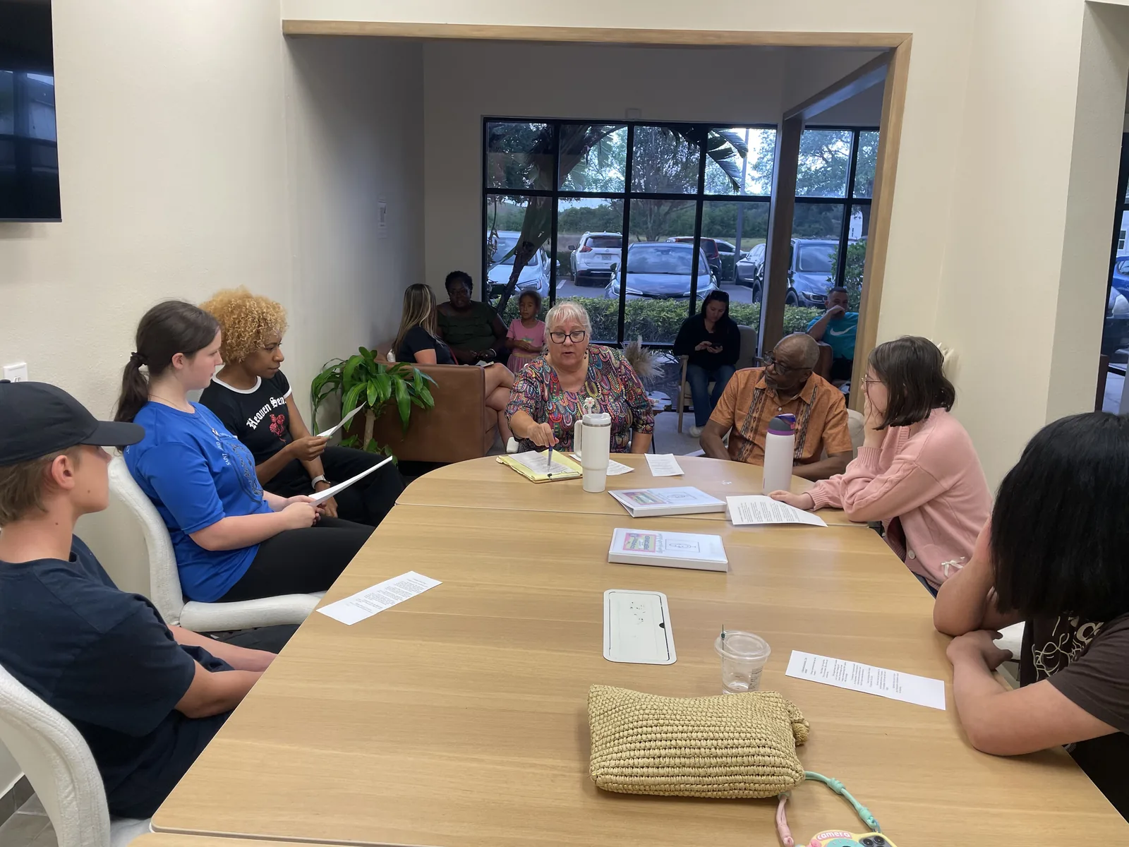 Students and instructors reading through a script around a table