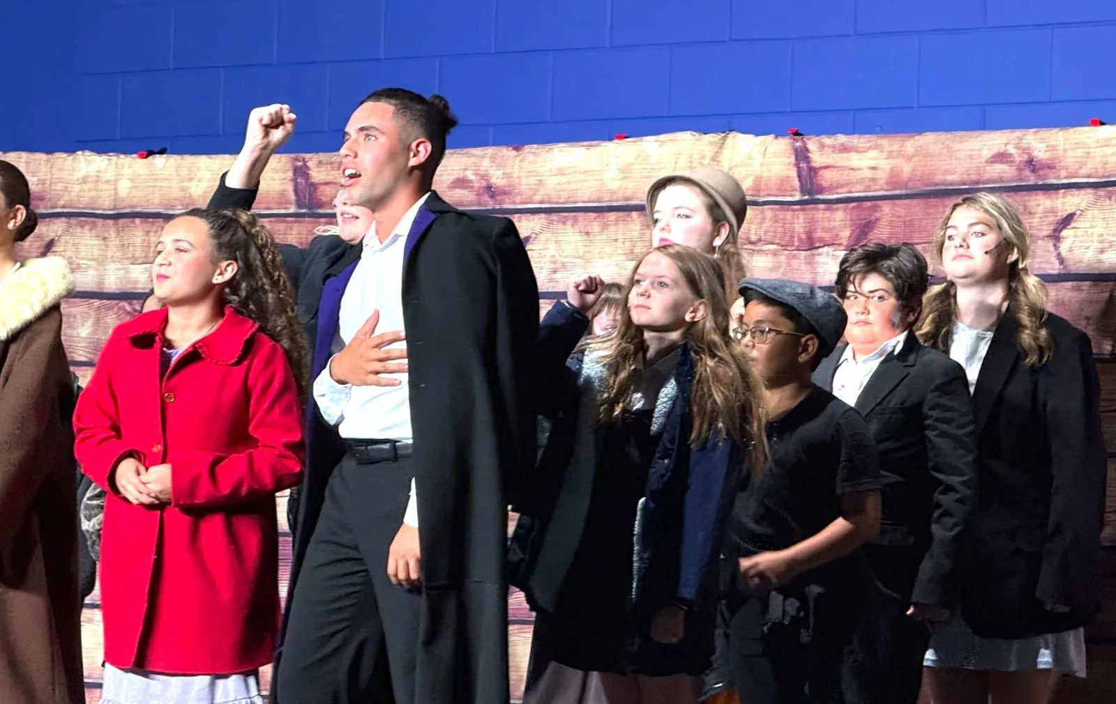 Students performing a musical theater scene in costume