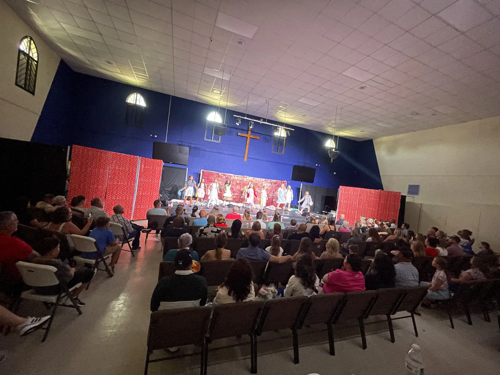 Families filling the theater seats for a Joy Music Studios performance